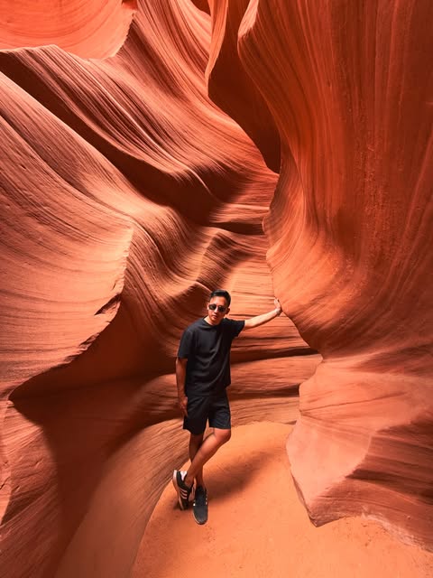 Mark standing among curved red canyon walls